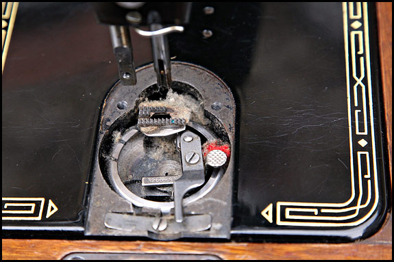 fluff under needle plate of Singer 99k sewing machine